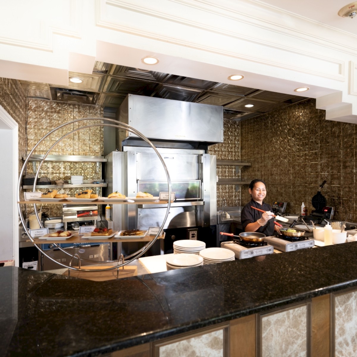 Modern kitchen with a chef behind the counter, ready to prepare a meal.