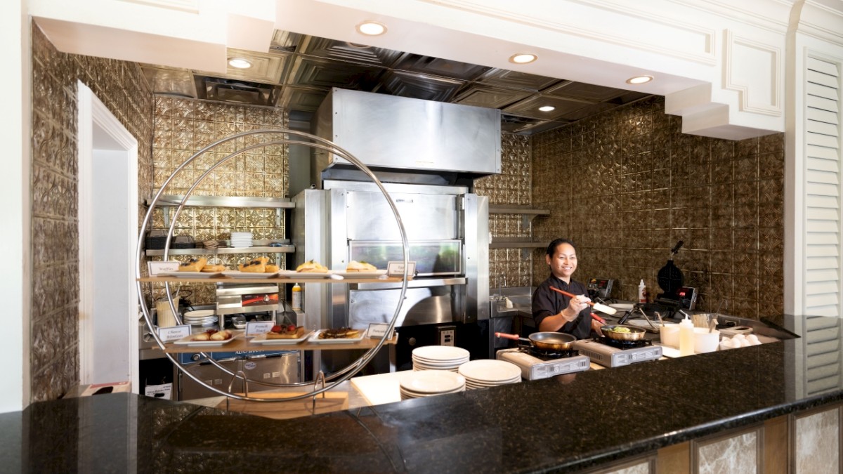 Modern kitchen with a chef behind the counter, ready to prepare a meal.