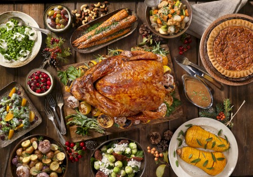 The image shows a Thanksgiving feast with a roasted turkey, stuffing, pie, cornbread, vegetables, mashed potatoes, cranberries, and assorted side dishes.