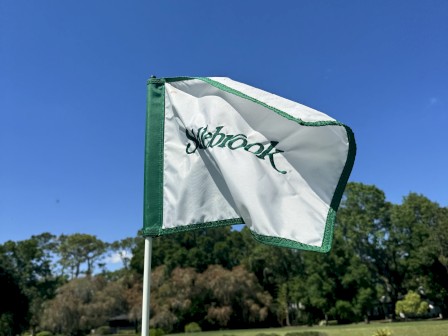 A golf course flag with the name 